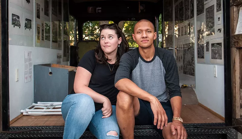 Image: Corianne Wells and Kristopher Wright sit outside Grafico Movil, a multi-community collaborative art project.