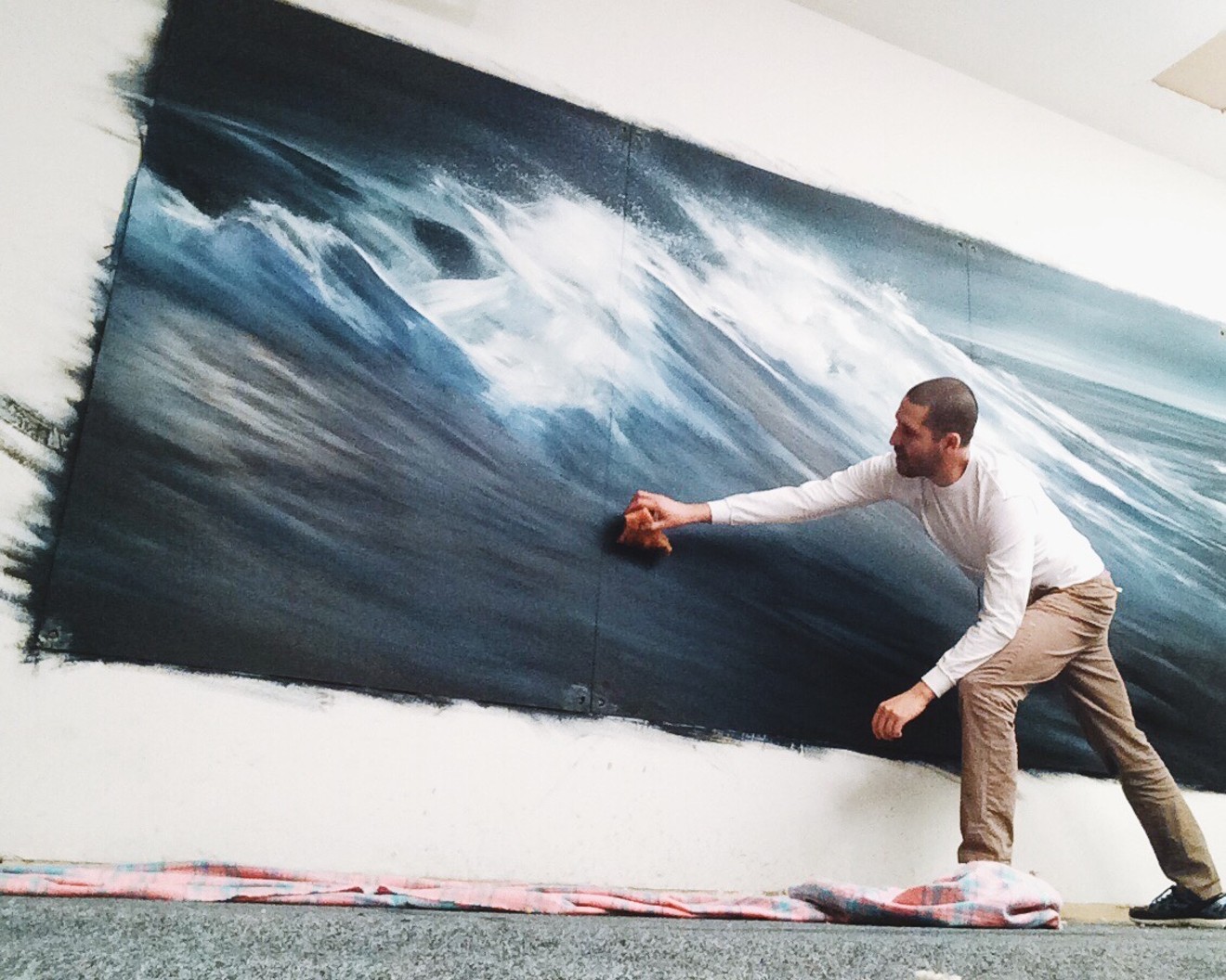 Jonathan Saiz at work on a wall mural.