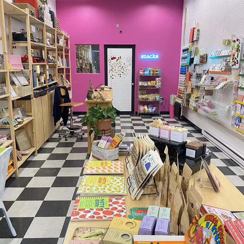 Image: A shop with black and white tiles and pink walls