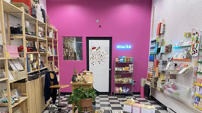 A shop with black and white tiles and pink walls