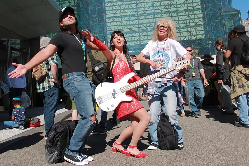 Image: Three people dressed up as Wayne, Cassandra, and Garth from Wayne's World at New York ComicCon 2019.