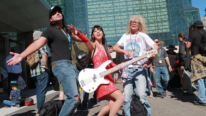 Three people dressed up as Wayne, Cassandra, and Garth from Wayne's World at New York ComicCon 2019.