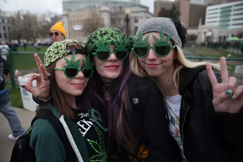 Image: women wearing marijuana leaf sunglasses