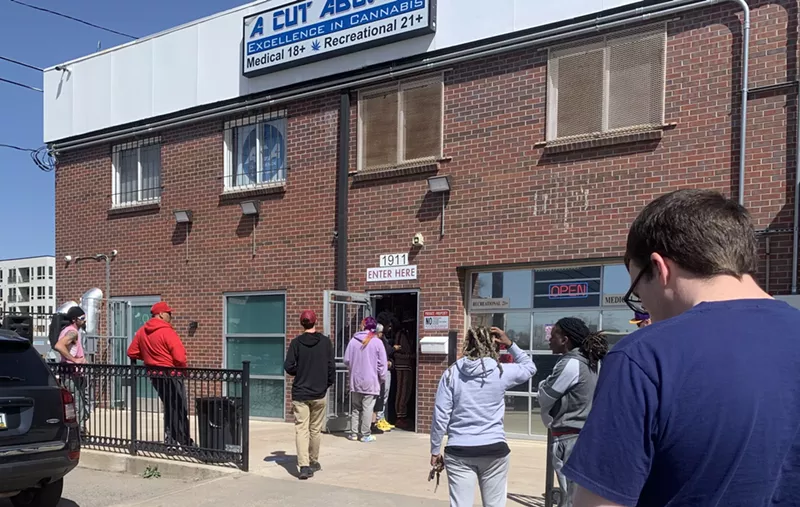 Image: Customers begin to line up outside of A Cut Above dispensary on the morning of Wednesday, April 20.