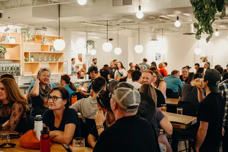 Image: a crod of people inside a brewery