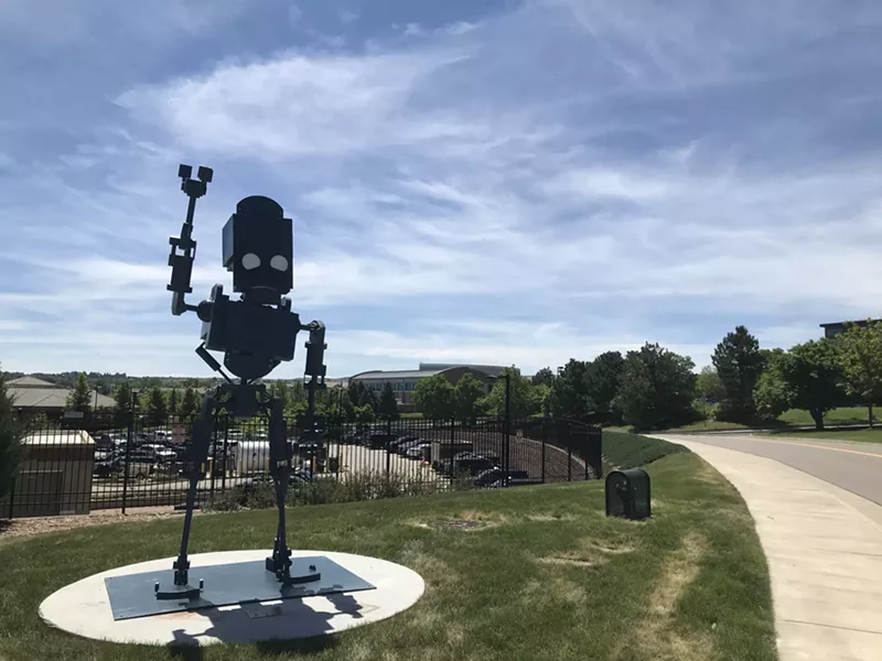 Image: Even Chris Mora is unsure what to make of his robot standing outside the sheriff's station.