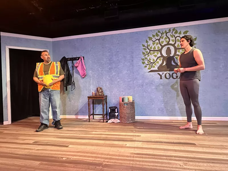 Image: a construction worker and yoga teacher in a yoga studio set in a theater