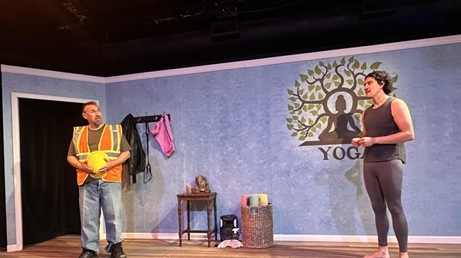 a construction worker and yoga teacher in a yoga studio set in a theater