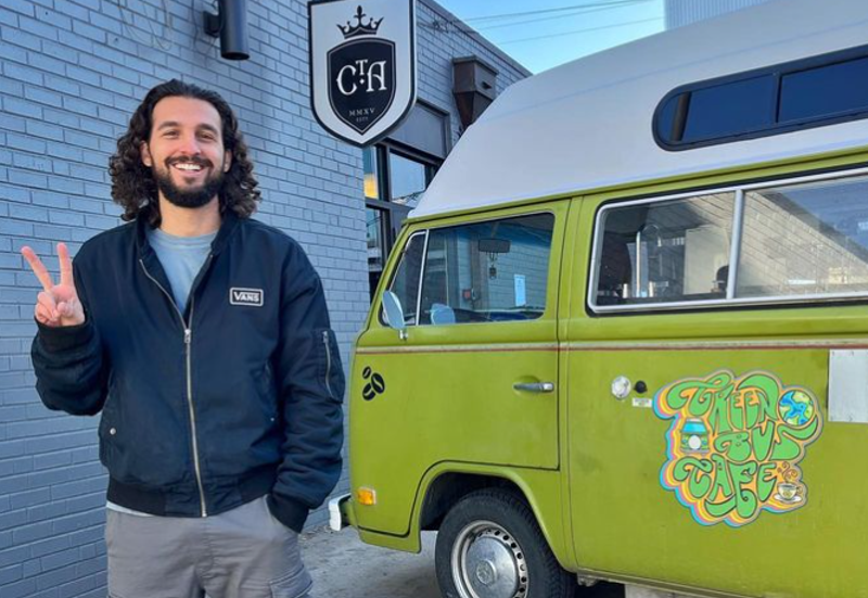 Image: a man standing next to a lime green VW bus