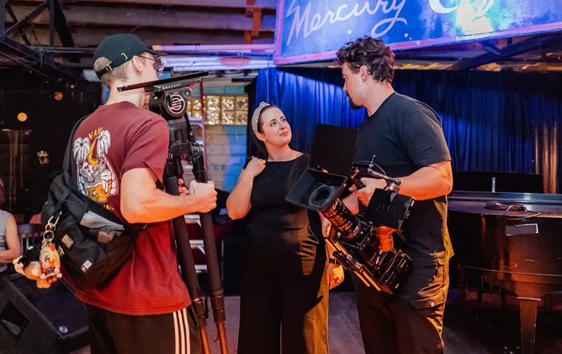 Image: Three filmmakers standing in a room