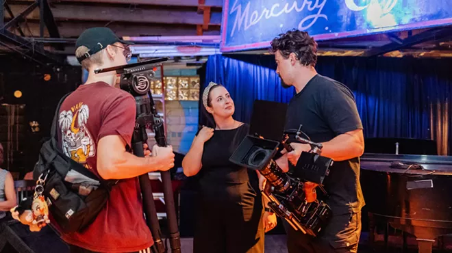 Three filmmakers standing in a room
