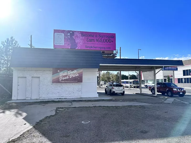 Image: the outside of a building with a car parked under an overhang