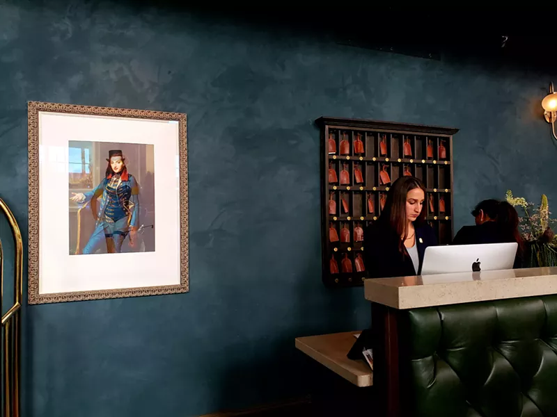 Image: Deborah Oropallo's "The Lion Tamer" hangs by the Ramble's front desk.