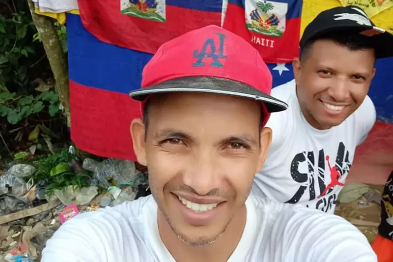 Image: A migrant takes a selfie at the Panama-Colombia border.