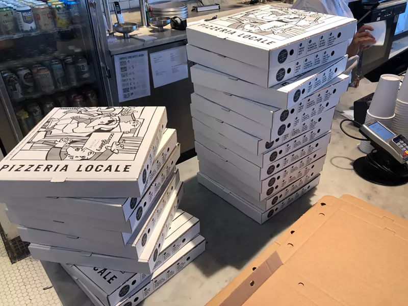Image: Pizza boxes at Pizzeria Locale printed with artwork by Javier Flores.