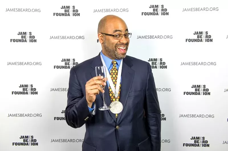 Image: Adrian Miller poses with his 2014 James Beard Award for his book, Soul Food.