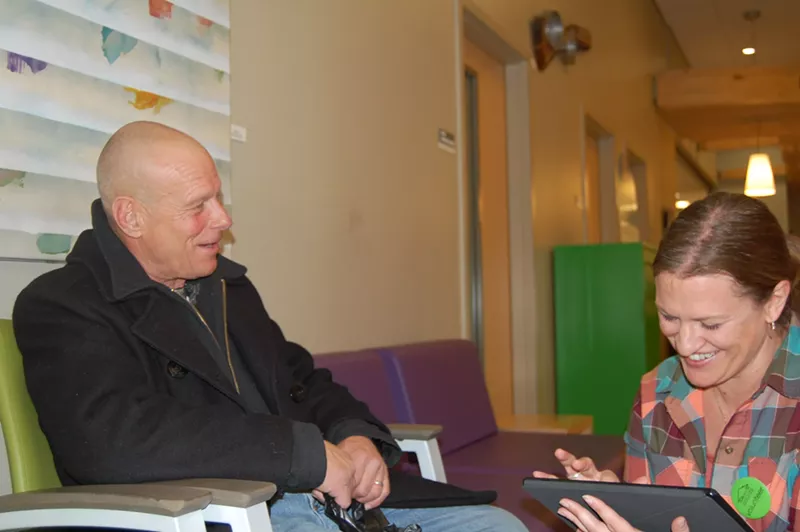 Image: Volunteer Katie Rollyson interviews Tim Abell at the Colorado Coalition for the Homeless Stout Street clinic.