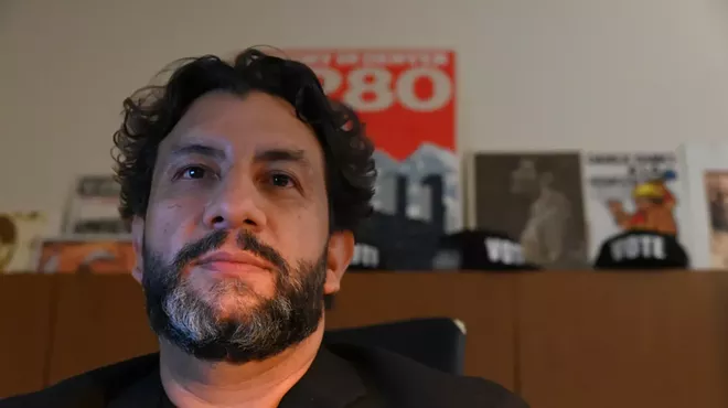 Paul López sits in his office.