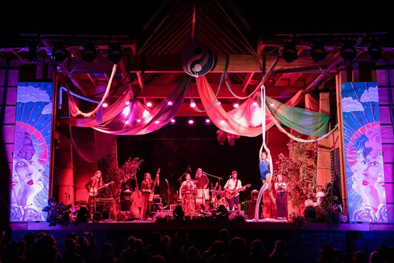Image: Elephant Revival performing on stage with an aerial silk artist