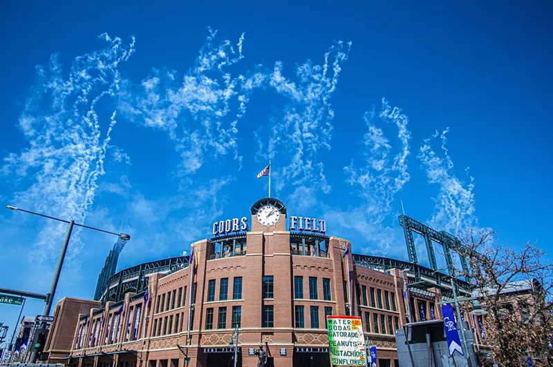 Image: coors field ballpark with sky and smoke from fireworks