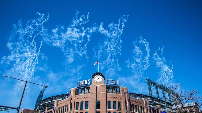 coors field ballpark with sky and smoke from fireworks