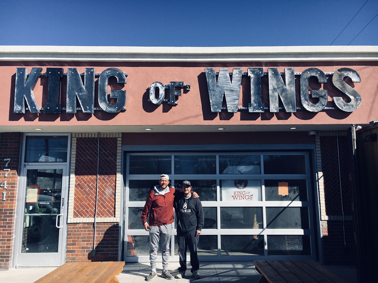 Eddie Renshaw (left) and Evan Pierce made the King of Wings sign above their new restaurant and taproom.