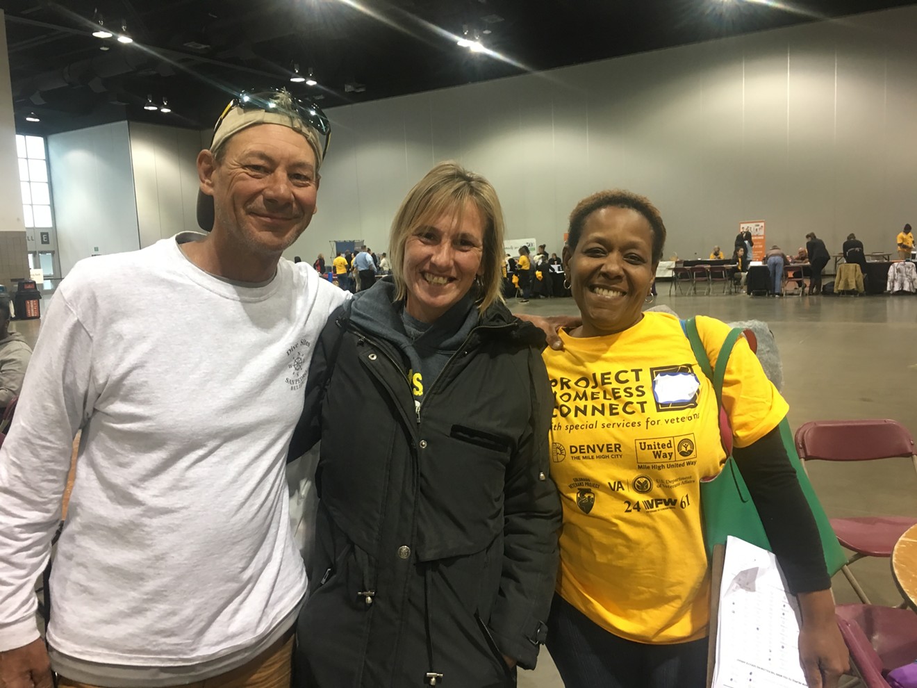 Volunteer Kim (right) stands with the two people she helped navigate services: Robert Harris and Sabrina Lugo.