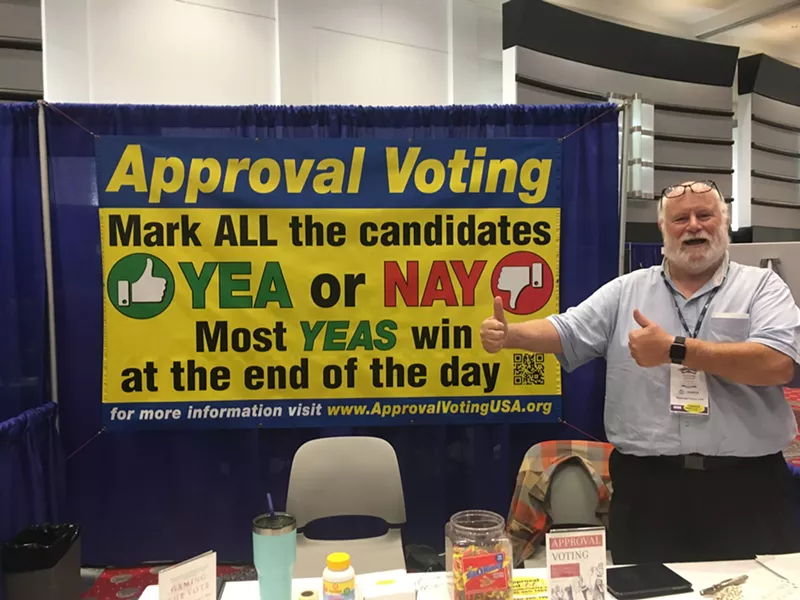 Image: Approval Voting Party secretary Blake Huber demos how easy it is to say "yea" or "nay" at a booth at the 2019 Western Conservative Summit.