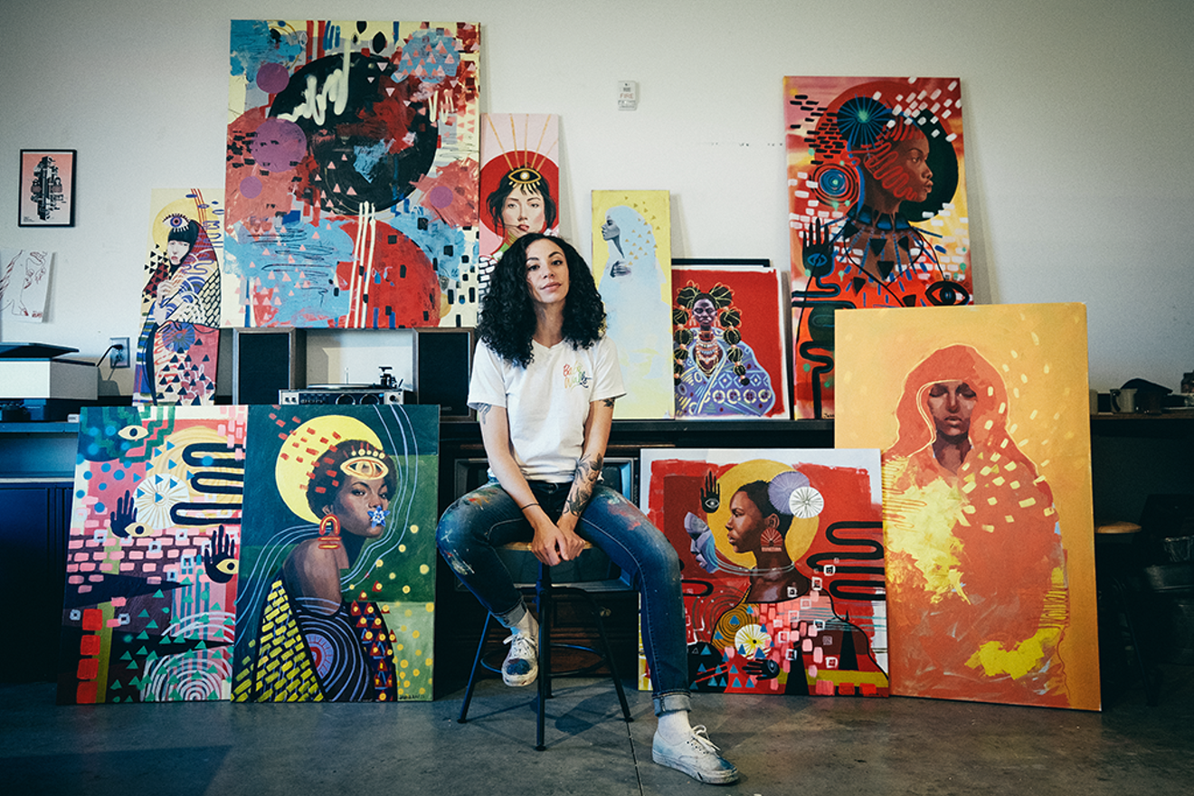 Jahna Rae Church poses with her paintings. See her work at PlatteForum.
