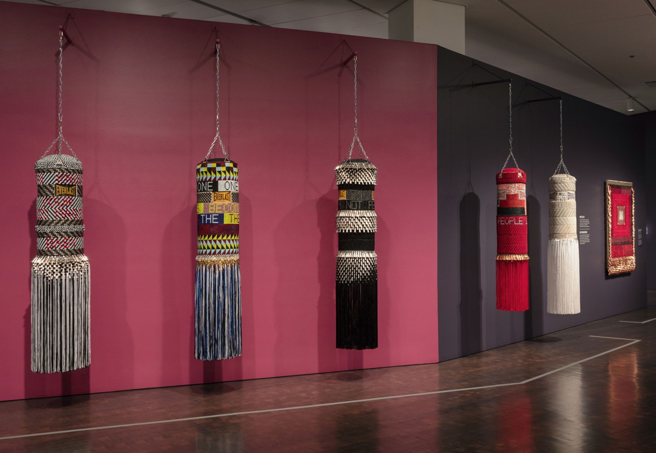 Adorned punching bags by Jeffrey Gibson, found and ready-made materials.
