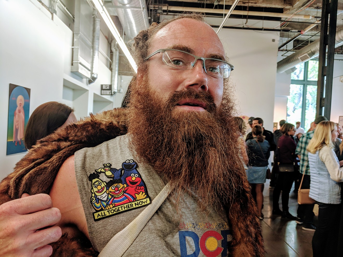 Artist Kenneth Wheeler in a fur coat and patches from Denver Pop Culture Con.