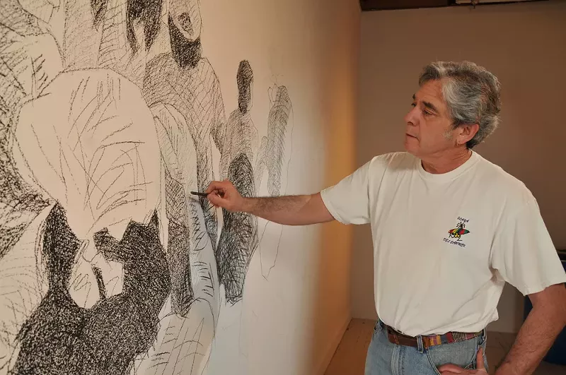 Image: Artist Tony Ortega drawing on the wall of the Boulder Museum of Contemporary Art.