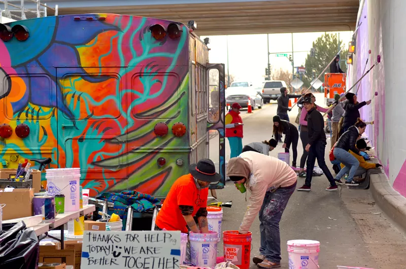 Image: Volunteers join members of the So-Gnar Creative Division to paint the south side of the 38th Street underpass on Saturday, November 18, 2017.