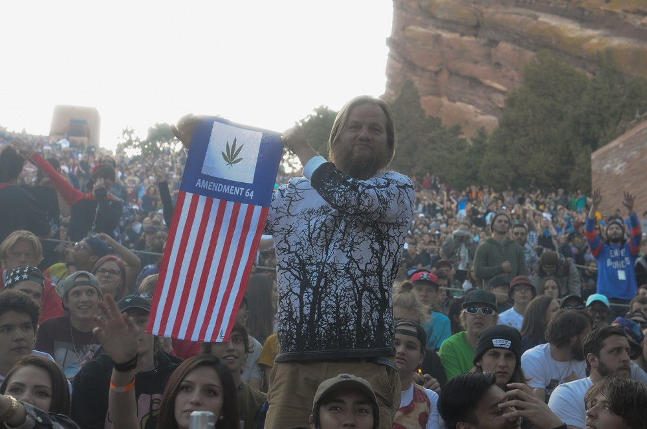 An attendee at Red Rocks Ampitheatre waves a flag honoring Amendment 64, the voter initiative that legalized marijuana in 2012.