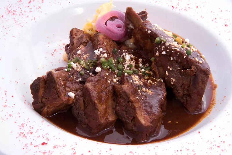 Image: Pork ribs doused in mole de chilhuacle.