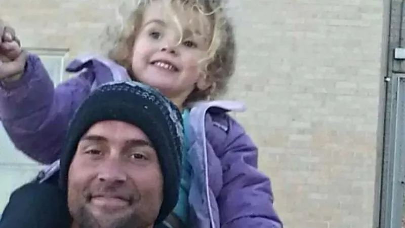 Image: The late Jeffrey Lillis with one of his kids.