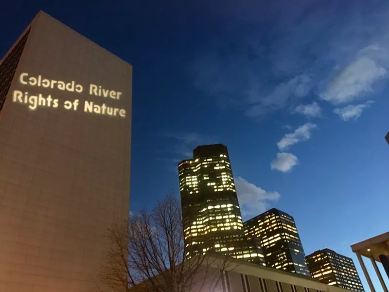 Image: Messages were beamed on the side of a federal building using a projector on Friday.