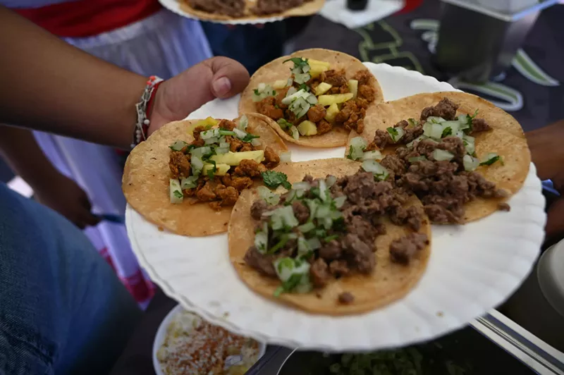 Image: a plate of four street tacos