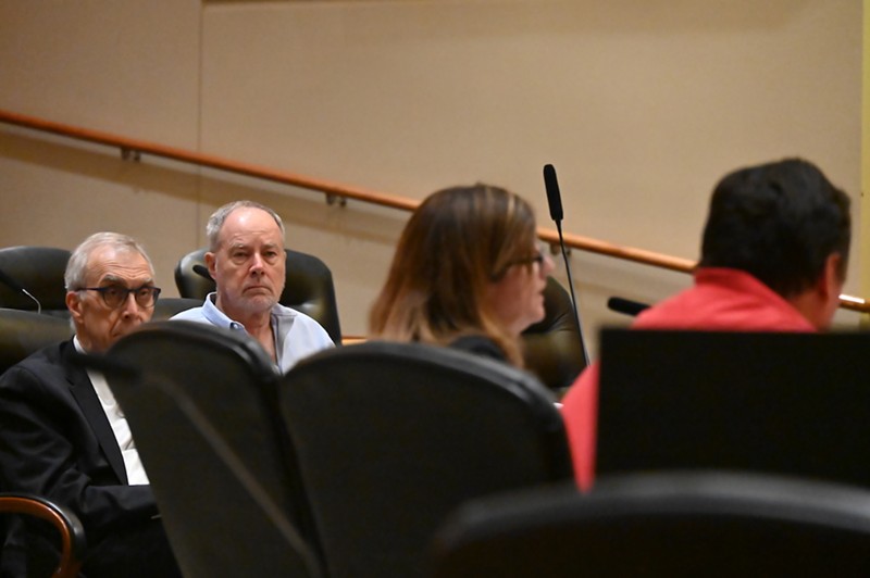 Former Aurora city official Charlie Richardson and his attorney Mark Grueskin listen to Suzanne Taheri defend the strong mayor proposal before Kadee Rodriguez at a protest hearing on Wednesday.