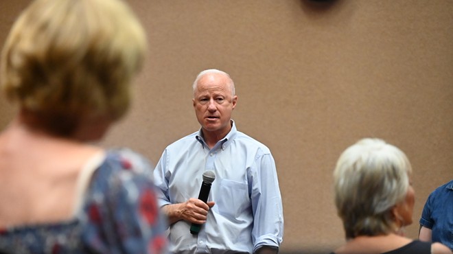 Aurora Mayor Mike Coffman listens to residents during a July town hall.