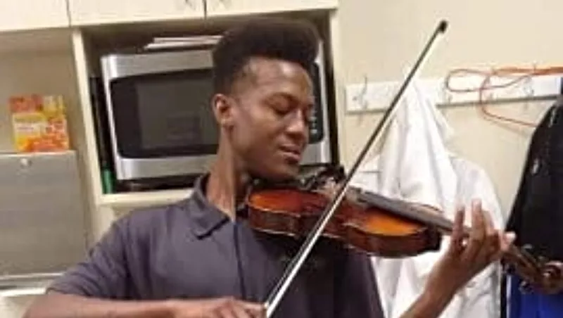 Image: The late Elijah McClain playing violin, one of his favorite pastimes.