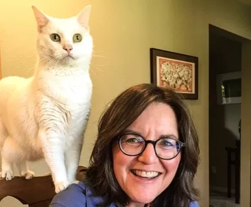 Image: R. L. Maizes sits with her own pet, who looks very surprised to be in the photo.