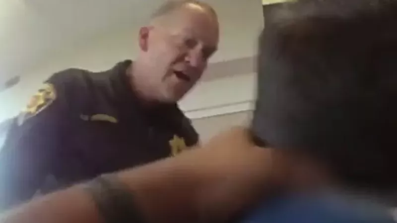 Image: A resource officer and an autistic child known as A.V., as seen in a 2019 video released by the ACLU of Colorado.