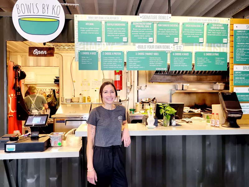 Image: Owner Katelin Overton in front of her food hall stall, Bowls by Ko.