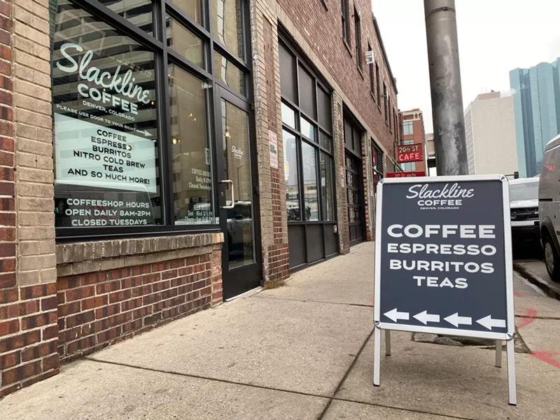 Image: sandwich board sign in front of a brick building