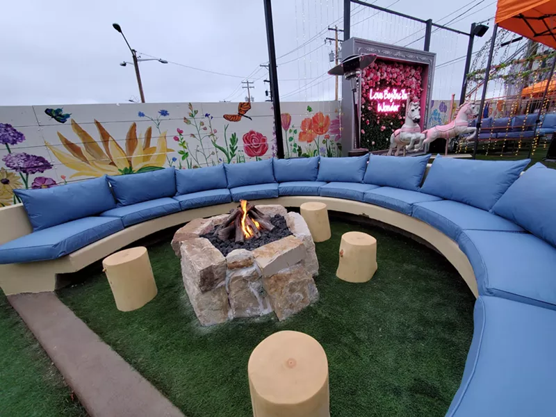 Image: a fire pit in front of a blue couch