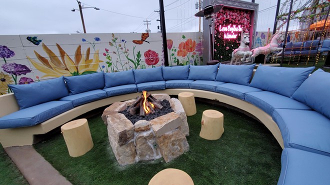a fire pit in front of a blue couch