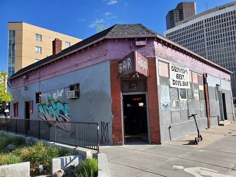Image: dive bar with purple walls.