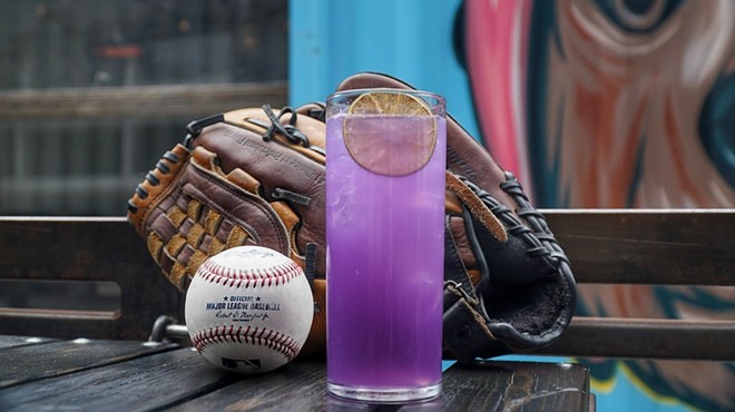 a purple cocktail in front of a baseball glove