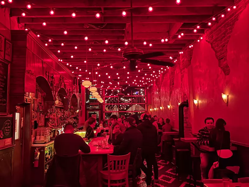 Image: interior of a red-hued bar